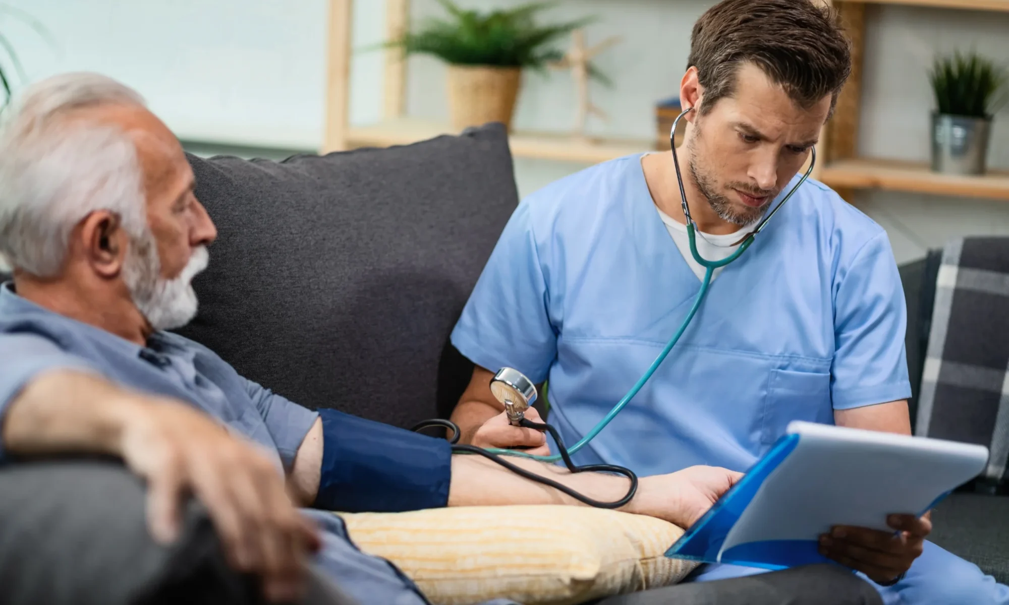 serious-healthcare-worker-measuring-blood-pressure-mature-man-while-going-through-his-medical-reports-home-visit