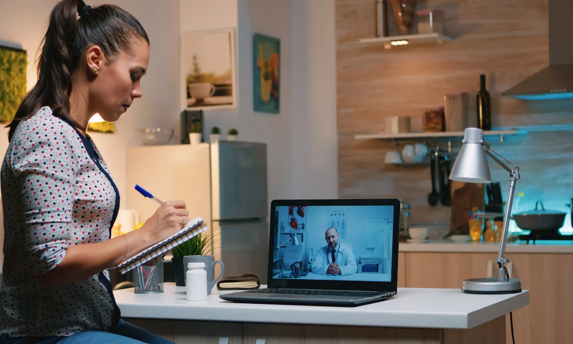 woman-speaking-online-with-doctor-taking-notes-tele-health-sitting-home-kitchen-sick-lady-discussing-virtual-consultation-about-symptoms-holding-notebook-writing-treatment (1)